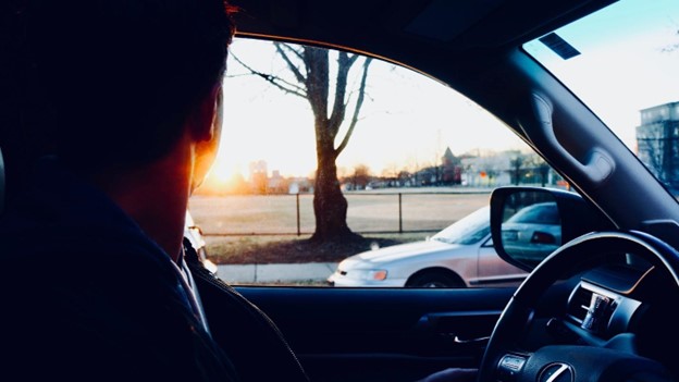 A person in a car looking out the window