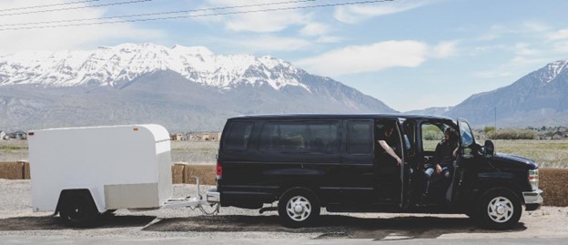 A black van with a large trailer