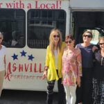 A group of women stands in front of a bus, ready for Nashville tours with local Nashville tour guides.
